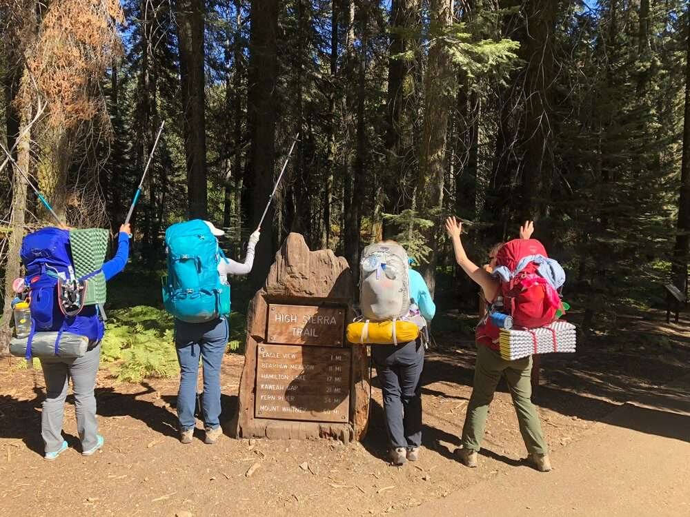 Women with backpacking packs on the High Sierra Trail in California