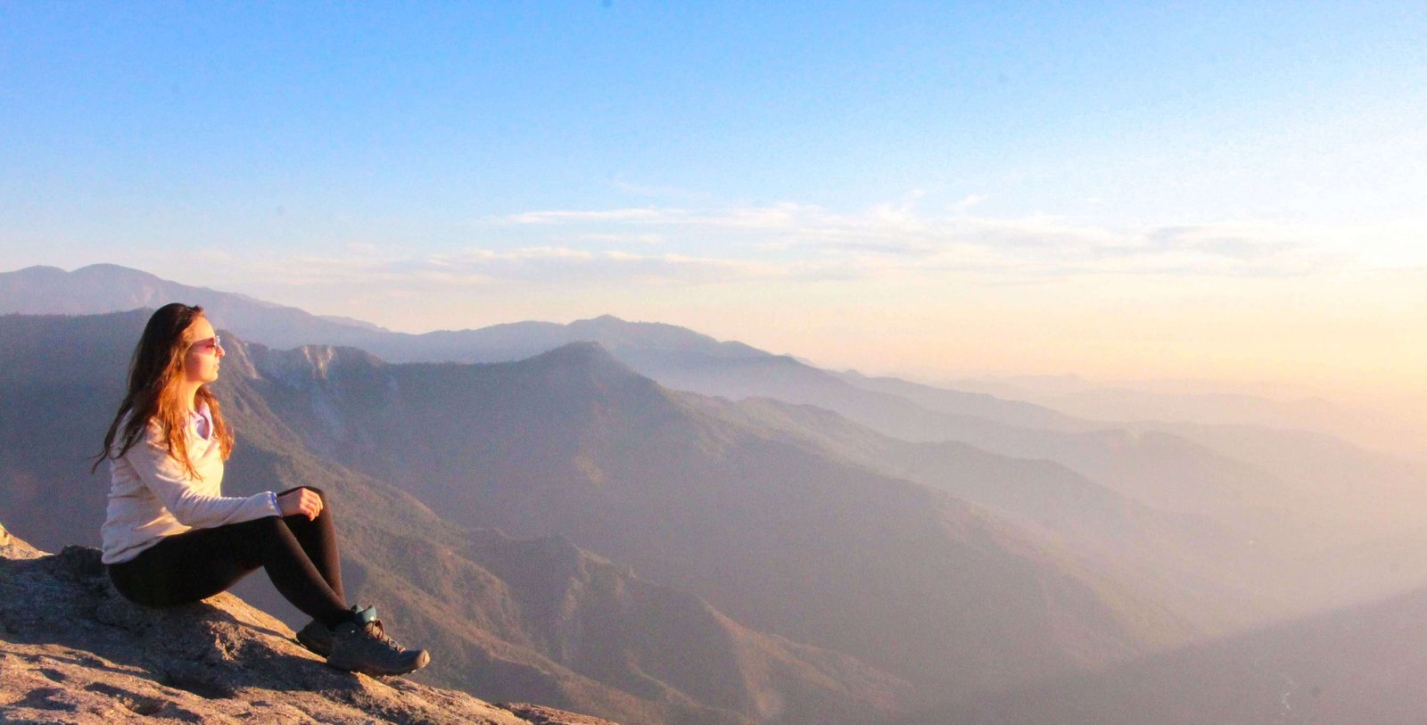 woman watching the sunset on mountain
