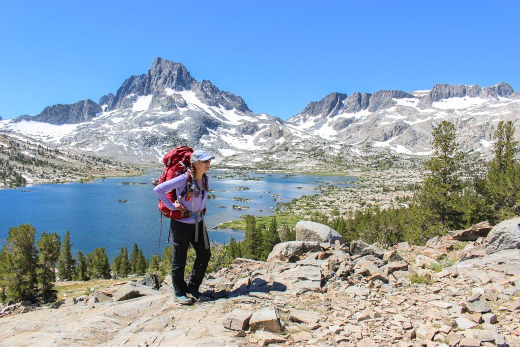 Woman backpacking on a trail in california