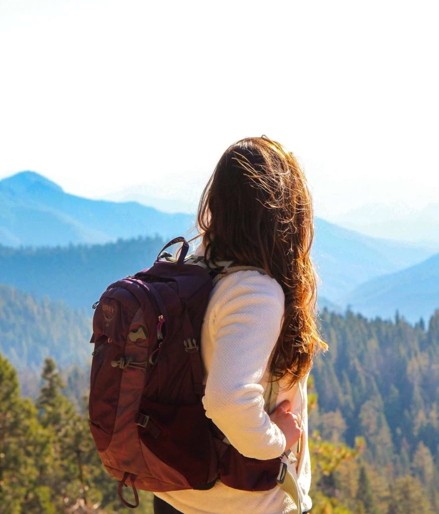 Woman with a backpack overlooking mountains