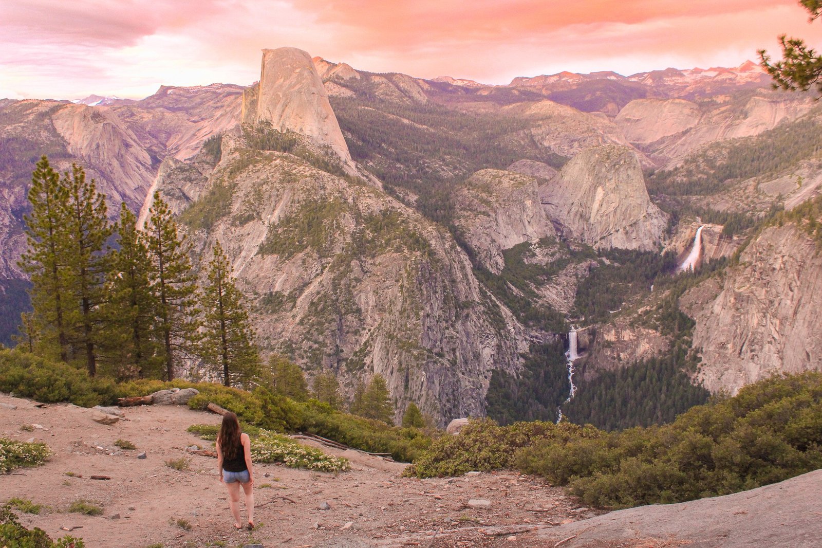 Woman overlooking Half Dome in Yosemite during sunset