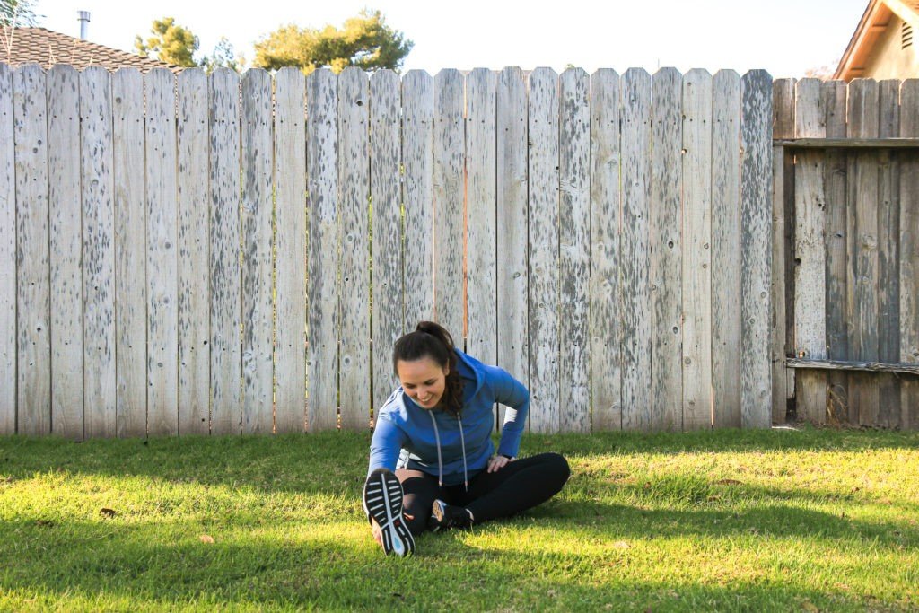woman stretching on grass