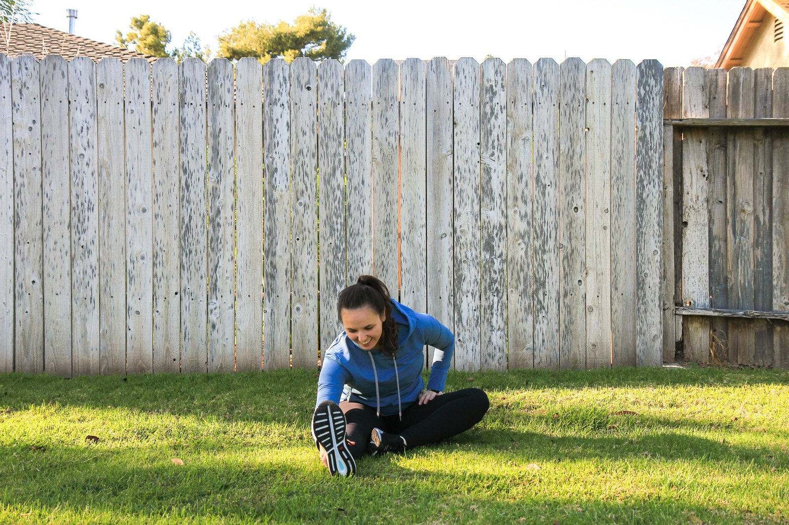 woman stretching on grass