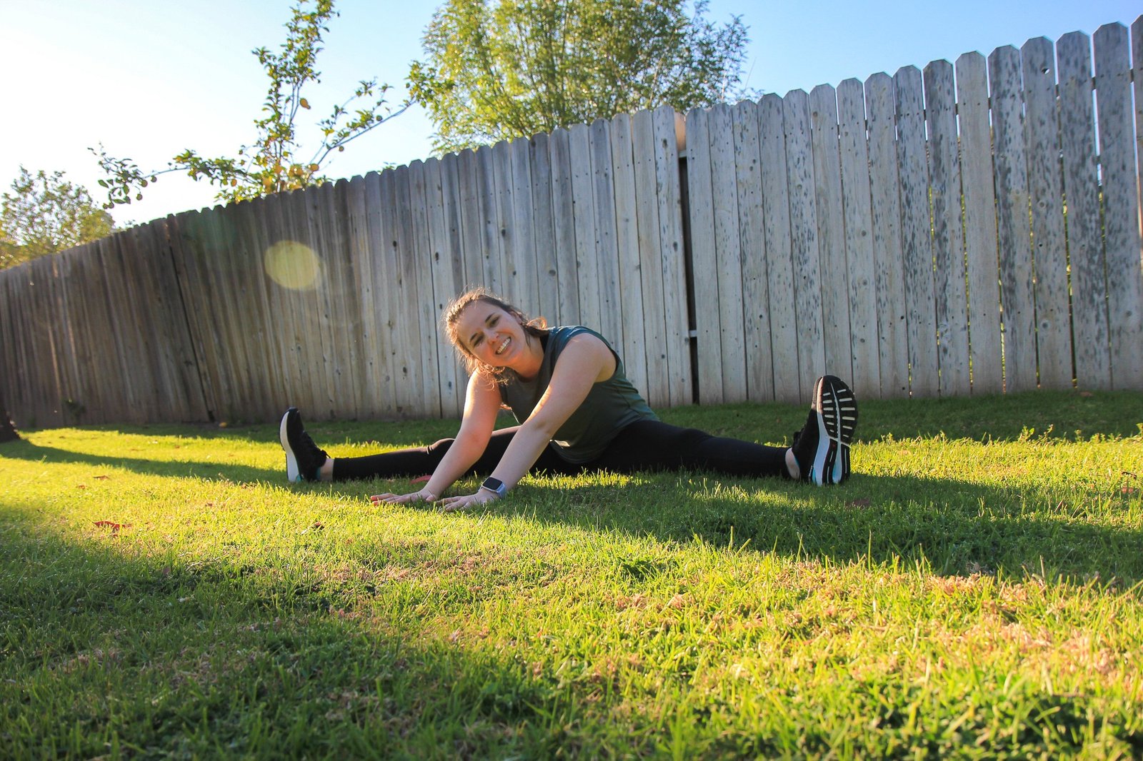 woman stretching on grass