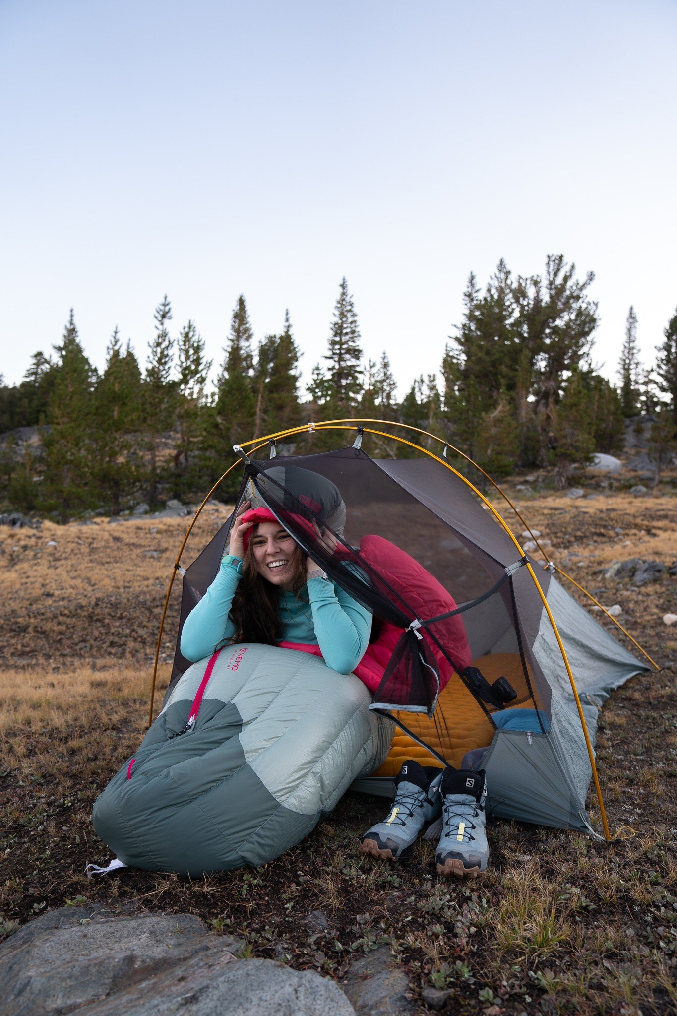 woman in a sleeping bag in a tent backpacking