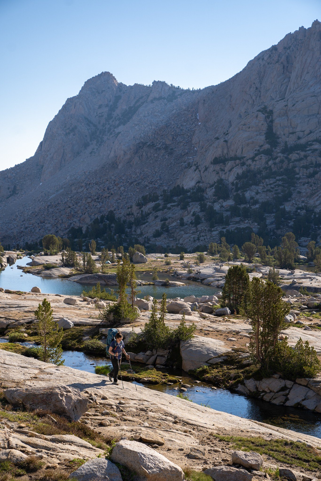 woman hiking in the sierra nevada mountains in california by lakes in hungry packer