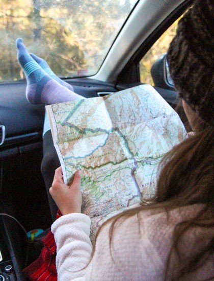 Woman with map in the car