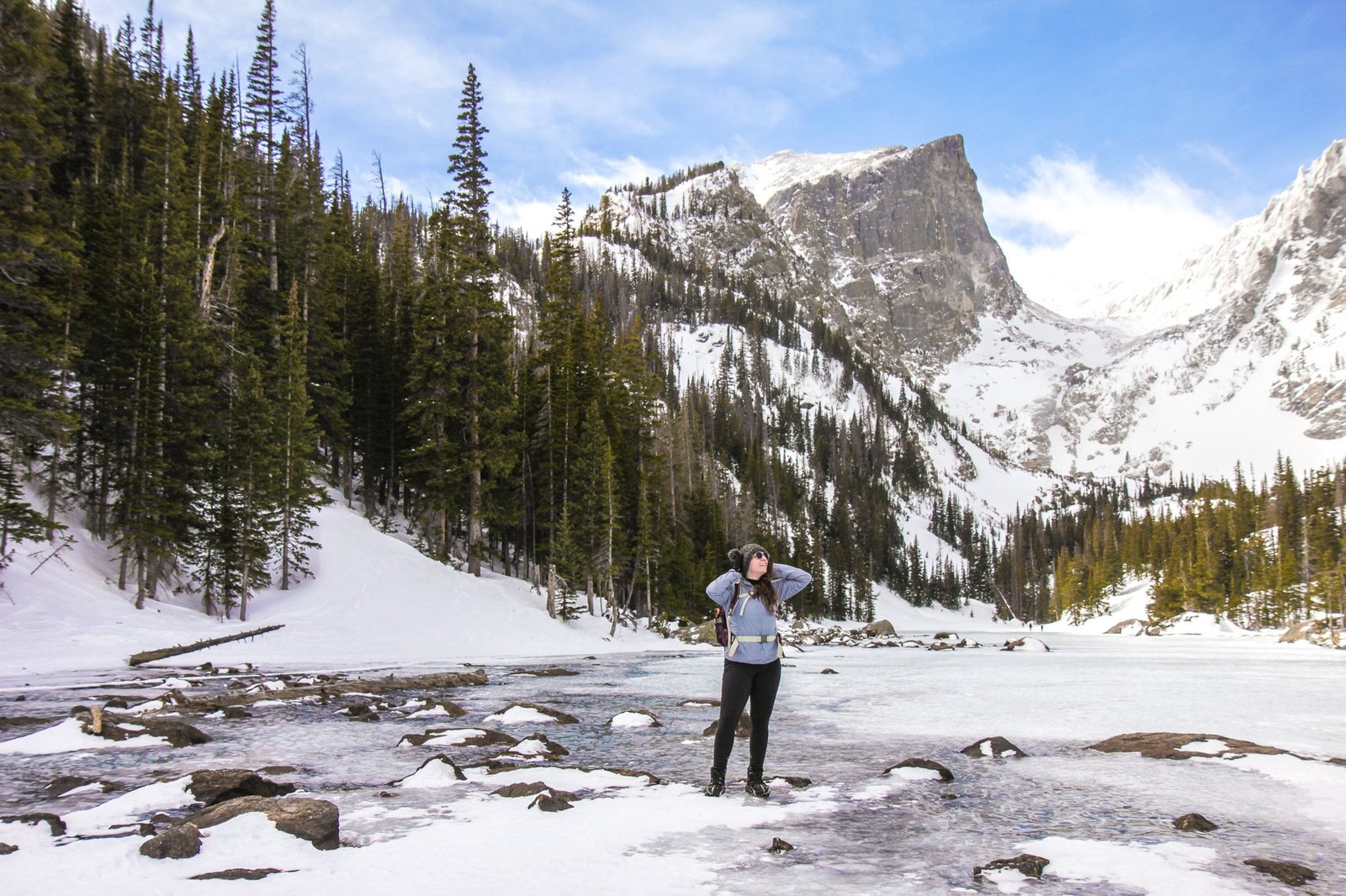 woman over a frozen lake in Rocky Mountain National Park