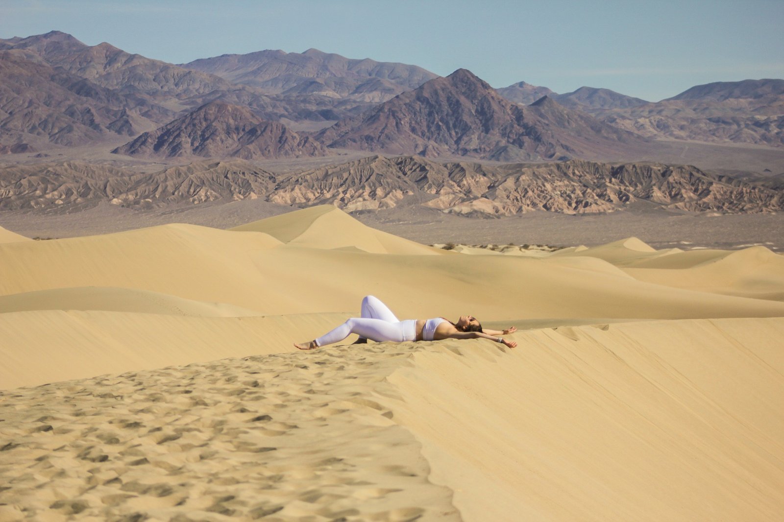 woman laying down on the sand in Death Valley National Park 2