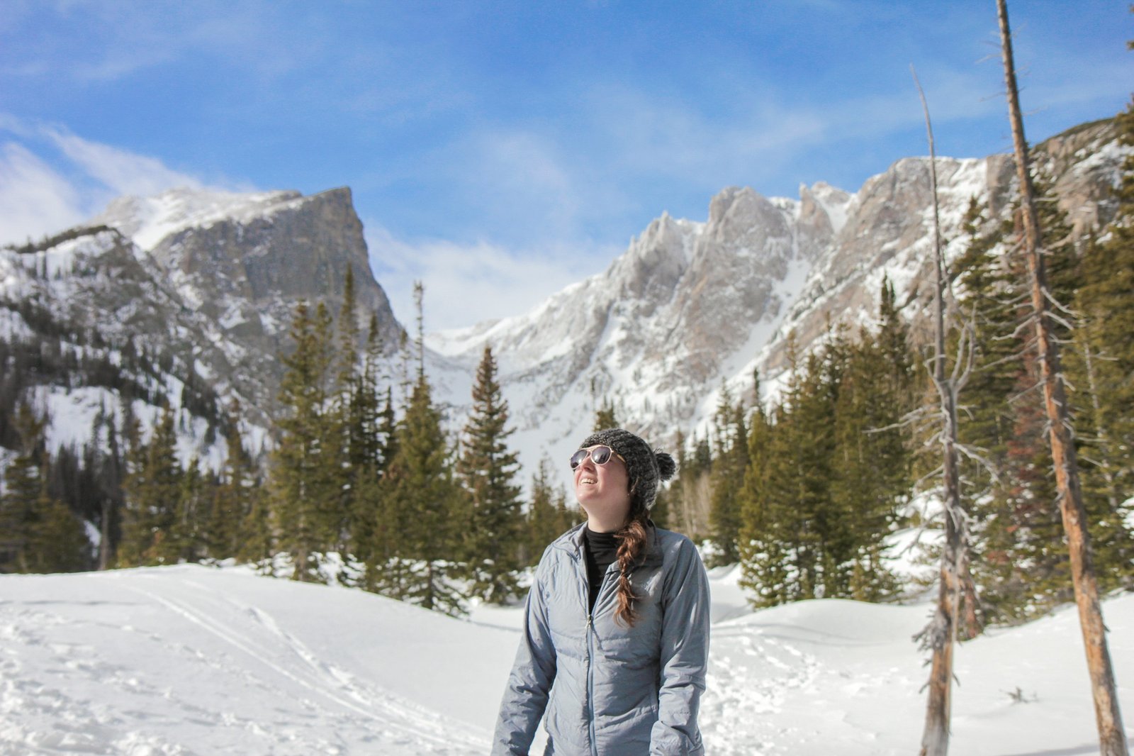 woman looking at the sun during hike in Rocky Mountain national park